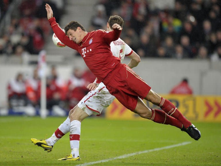 Munich forward Mario Gomez takes a tumble during the German Bundesliga match against Stuttgart on January 27, 2013. Bayern Munich won 2-0 to open up an 11-point lead at the top of the Bundesliga