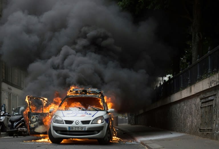 A police car is set on fire during riots in Paris on May 18, 2016