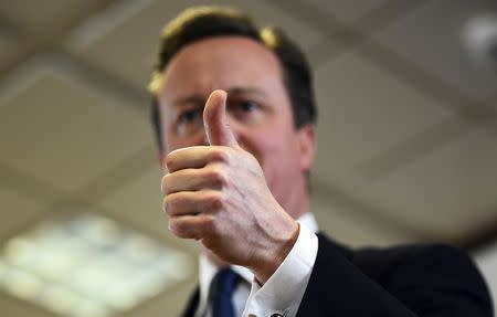 British Prime Minister David Cameron gestures as he addresses the media after a European Union leaders' summit in Brussels, Belgium, February 19, 2016. REUTERS/Dylan Martinez