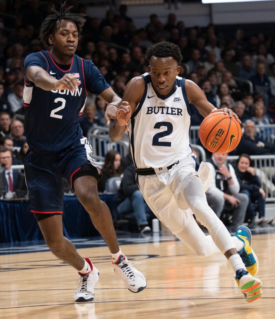Butler Bulldogs guard Eric Hunter Jr. (2) drives past Connecticut Huskies guard Tristen Newton (2) on Saturday, Dec. 17, 2022, at Hinkle Fieldhouse in Indianapolis. 
