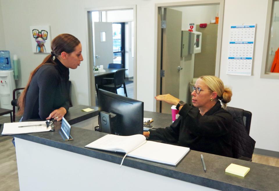 Brockton Community Justice Support Center Career Specialist Monique Viola, left, chats with Administrative Coordinator Michelle Phillips on Tuesday, Dec. 13, 2022.