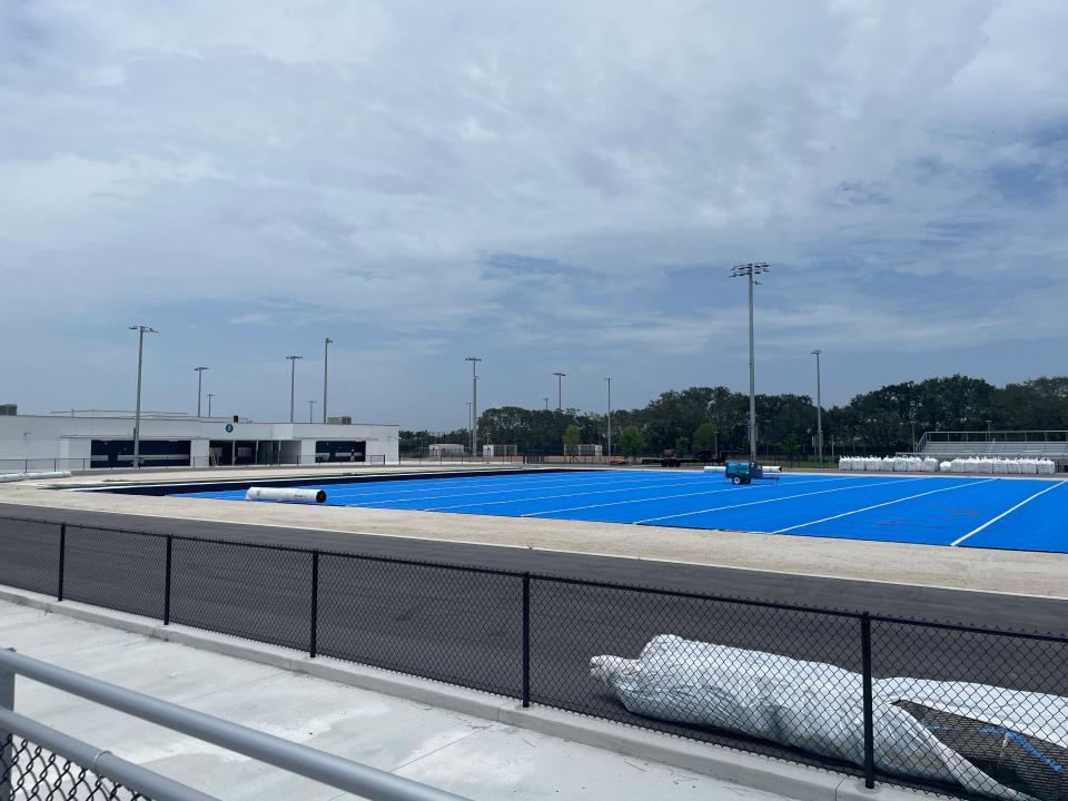 Bright blue turf is rolled over the football field at Dr. Joaquín García High School on Thursday.