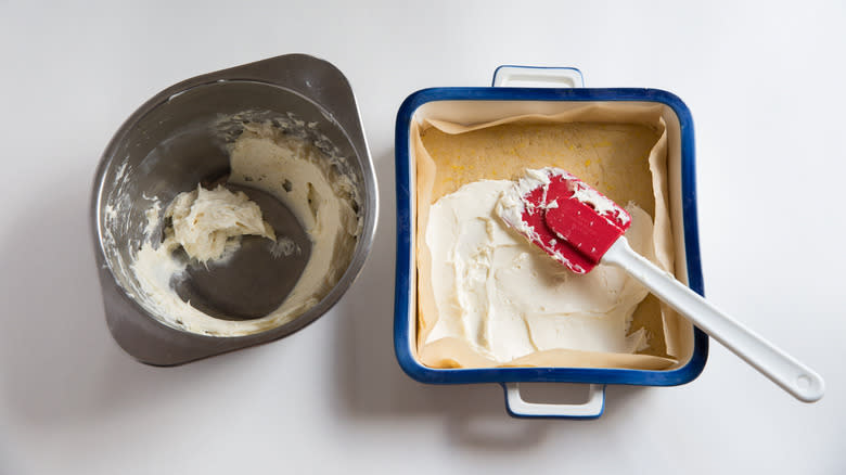 spreading cream cheese in pan