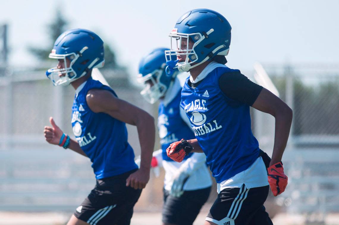 Federal Way High School defensive back Andre Jordan Jr. runs through a drill with teammates on the first day of practice on Wednesday, Aug. 17, 2022 in Federal Way, Wash.