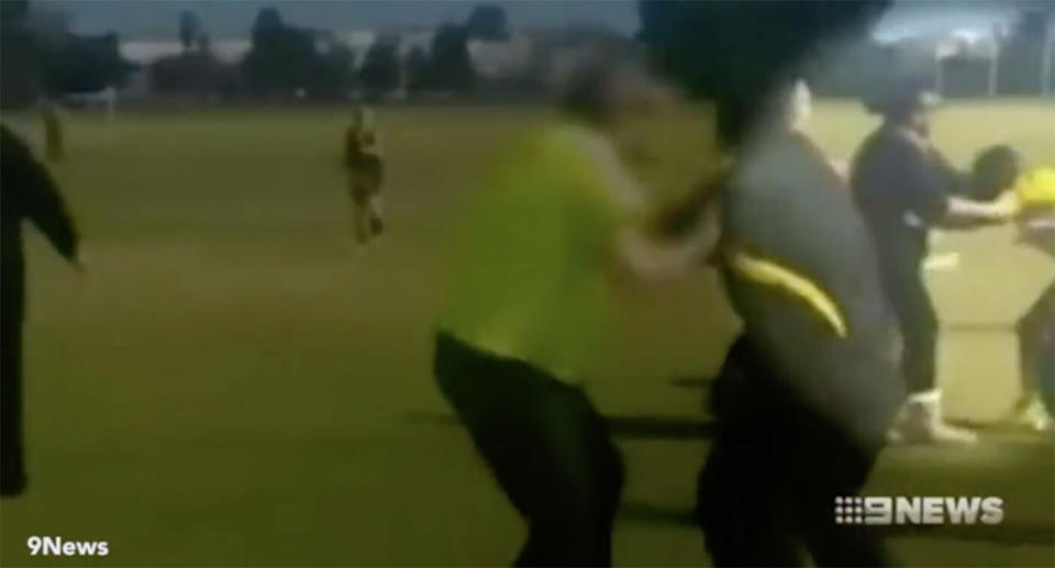 A woman can be seen appearing to put the 13-year-old umpire in a head lock at Perth's Tom Bateman Reserve. Source: 9 News