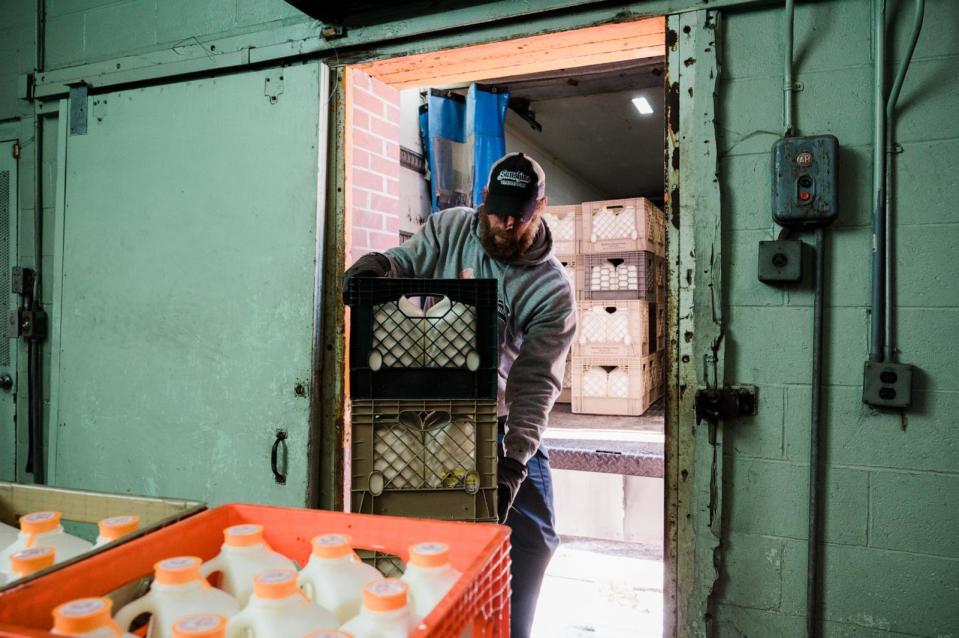PHOTO:A delivery driver, loads a delivery truck with milk and other dairy products in Maine, Feb. 1, 2022.  (Tristan Spinski for The Washington Post via Getty Images)