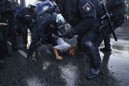 German riot police detain a protester during the demonstrations during the G20 summit in Hamburg, Germany, July 6, 2017. REUTERS/Pawel Kopczynski