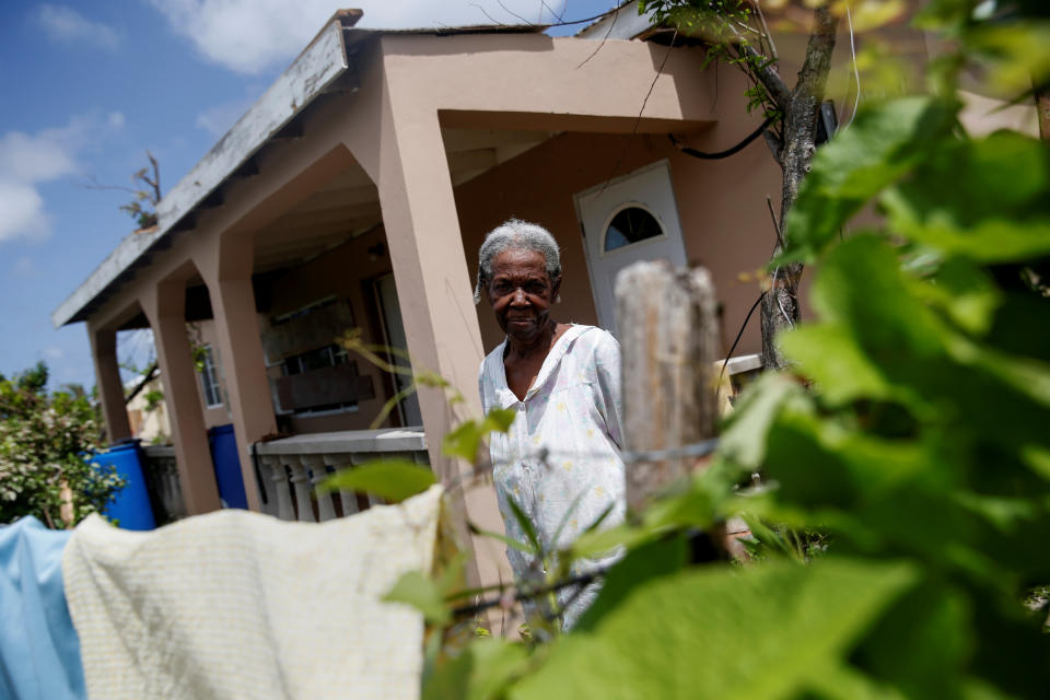 Miriam Harris, who stayed in her home during Hurricane Irma, poses outside her home at Codrington on the island of Barbuda just after a month after the hurricane struck the Caribbean islands of Antigua and Barbuda