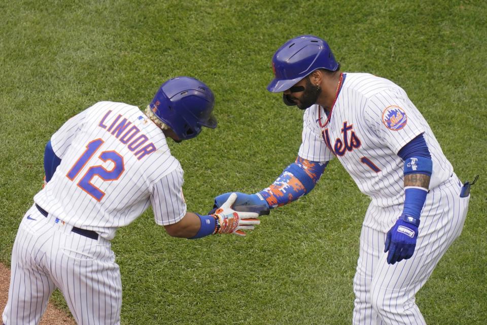 New York Mets' Francisco Lindor (12) celebrates with Jonathan Villar (1) after Lindor hit a two-run home run during the first inning of a baseball game against the San Diego Padres, Saturday, June 12, 2021, in New York. (AP Photo/Frank Franklin II)