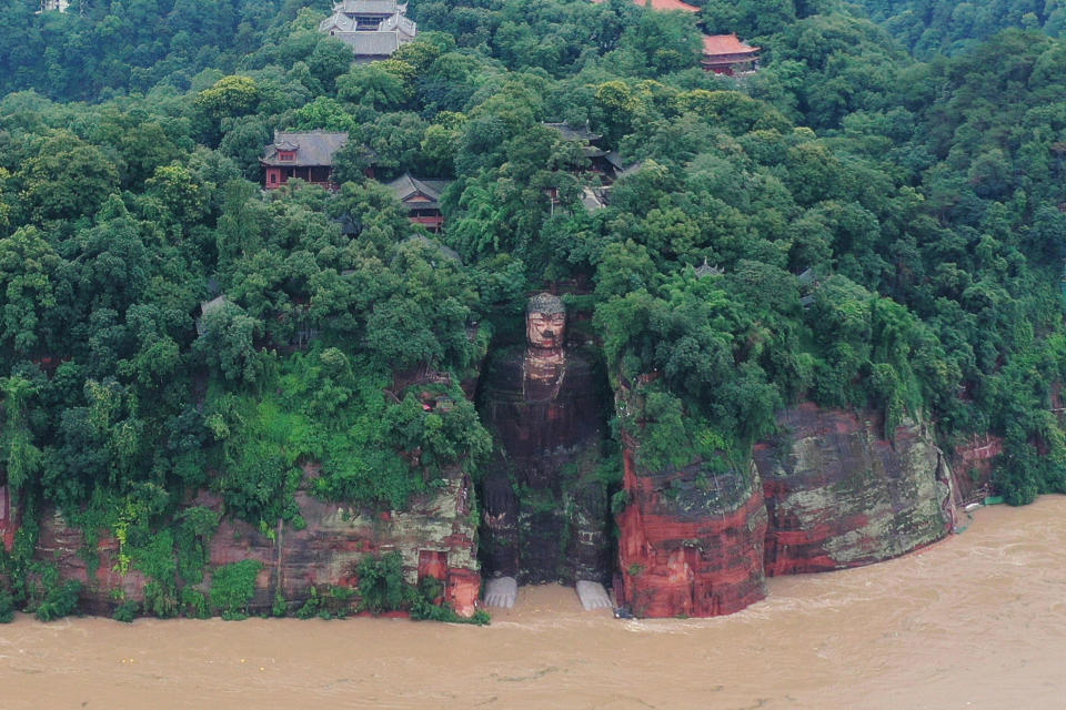 Floodwater reaches the Leshan Giant Buddha's feet following heavy rainfall, in Leshan, Sichuan province, China, August 18, 2020. / Credit: CHINA DAILY/REUTERS