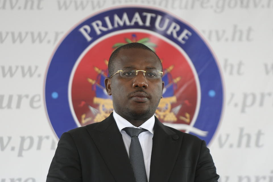 FILE - Interim Prime Minister Claude Joseph stands before delivering his speech during the appointment of Ariel Henry as the new Prime Minister in Port-au-Prince, Haiti, Tuesday, July 20, 2021, weeks after the assassination of President Jovenel Moise at his home. A judge investigating the July 2021 assassination of President Moïse issued a final report on Monday, Feb. 19, 2024, that indicts his widow, Martine Moïse, ex-prime minister Joseph and the former chief of Haiti’s National Police, Léon Charles, among others. (AP Photo/Matias Delacroix, File)