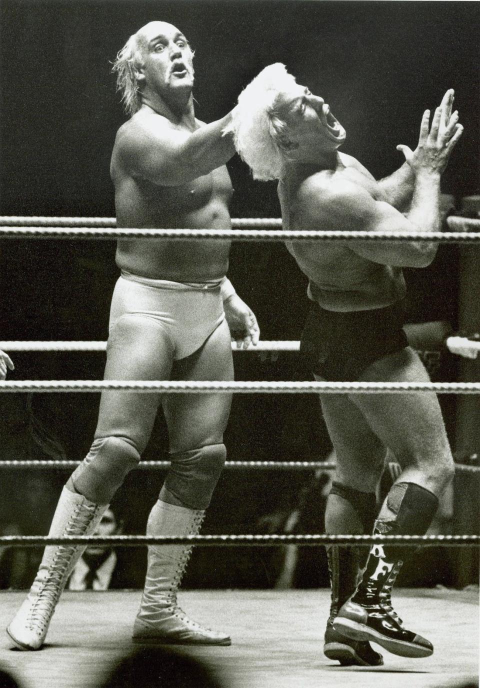 Jan. 3, 1991: Wrestler Hulk Hogan, left, delivers a right fist as Ric Flair grimaces in pain during their match at the Jacksonville Memorial Coliseum. (Dennis Hamilton Jr., The Times-Union)