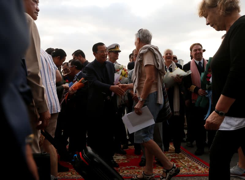 Cambodia's Prime Minister Hun Sen welcomes passengers of MS Westerdam, a cruise ship that spent two weeks at sea after being turned away by five countries over fears that someone aboard might have the coronavirus , as it docks in Sihanoukvil