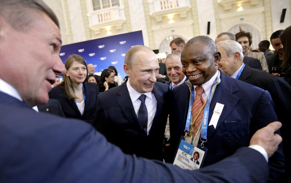 Russian President Vladimir Putin, center, greets International Olympic Committee members Habu Ahmed Gumel, right, and executive board member Sergei Bubka, left, at a welcoming event ahead of the upcoming 2014 Winter Olympics at the Rus Hotel, Tuesday, Feb. 4, 2014, in Sochi, Russia. (AP Photo/David Goldman, Pool)