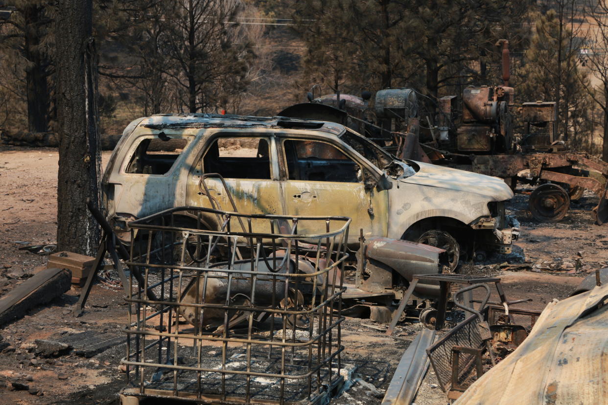 A burned car and piece of machinery are seen following a wildfire near Las Vegas, New Mexico, on Monday, May 2, 2022. Wind-whipped flames are marching across more of New Mexico's tinder-dry mountainsides, forcing the evacuation of area residents and dozens of patients from the state's psychiatric hospital as firefighters scramble to keep new wildfires from growing. The big blaze burning near the community of Las Vegas has charred more than 217 square miles. (AP Photo/Cedar Attanasio)