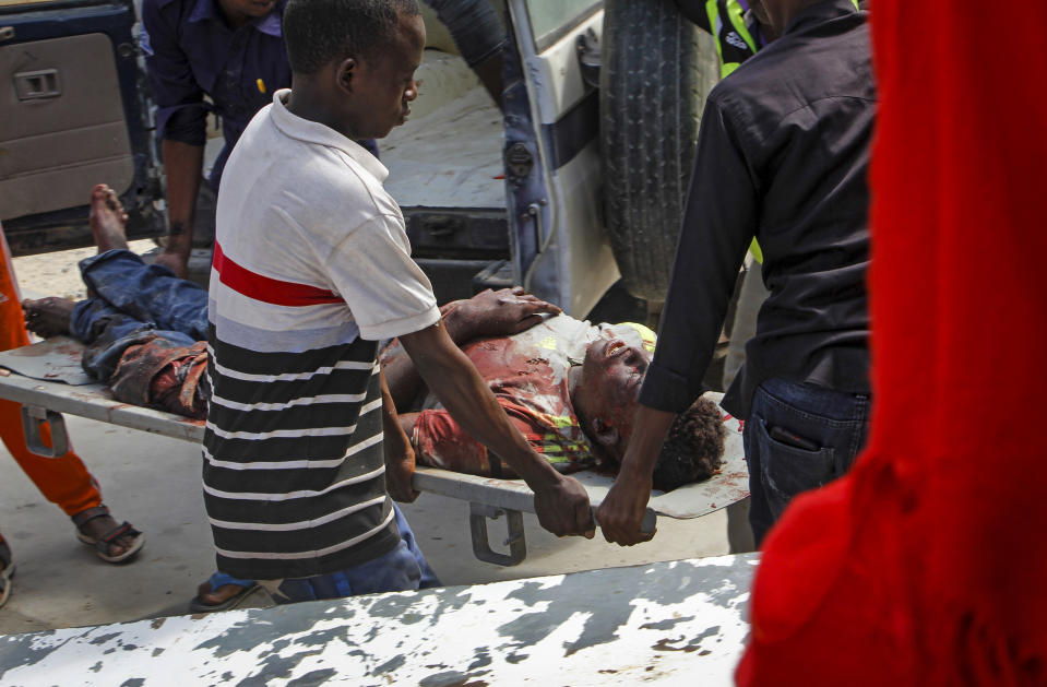 Medical workers help a man who was wounded in a bomb attack, at a hospital in the capital Mogadishu, Somalia, Saturday, June 15, 2019. (AP Photo/Farah Abdi Warsameh)