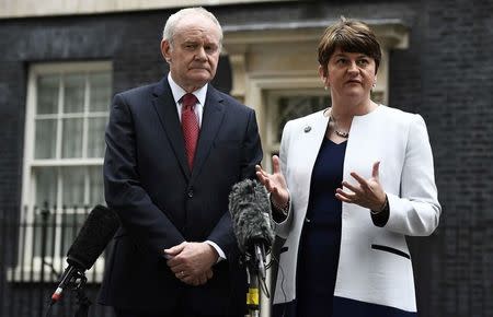 FILE PHOTO - Arlene Foster (R) and Martin McGuinness, First and Deputy First Ministers of Northern Ireland, speak to journalists as they leave Number 10 Downing Street in London, Britain October 24, 2016. REUTERS/Dylan Martinez/File Photo