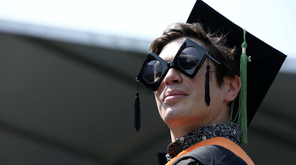 A graduate of The City College of New York stands in his seat at his commencement ceremony in Manhattan on May 31, 2019. (PHhoto: REUTERS/Gabriela Bhaskar)