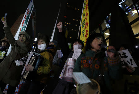 Protesters rising their fists shout slogans during an anti-nuclear rally in front of the headquarters of Tokyo Electric Power Co (TEPCO), the operator of the tsunami-crippled Fukushima Daiichi nuclear plant, a day before the five-year anniversary of the disaster, in Tokyo, Japan, March 10, 2016. REUTERS/Yuya Shino