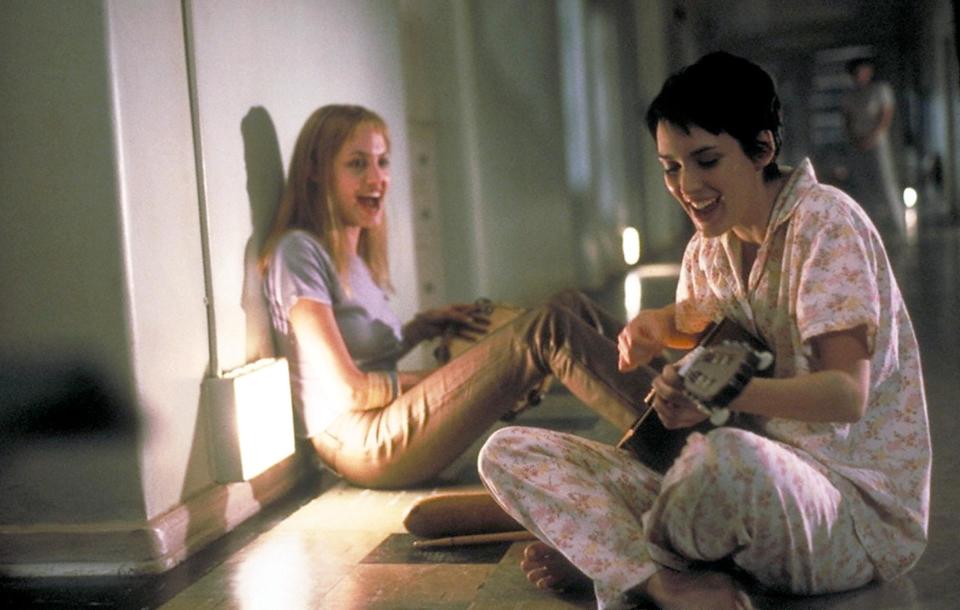 376554 03: After friend and fellow patient Polly lands herself in solitary, Lisa (Angelina Jolie, left) and Susanna (Winona Ryder) serenade her in the Columbia Pictures presentation, "Girl, Interrupted." Photo credit: Suzanne Tenner 1999 Columbia Pictures, Inc