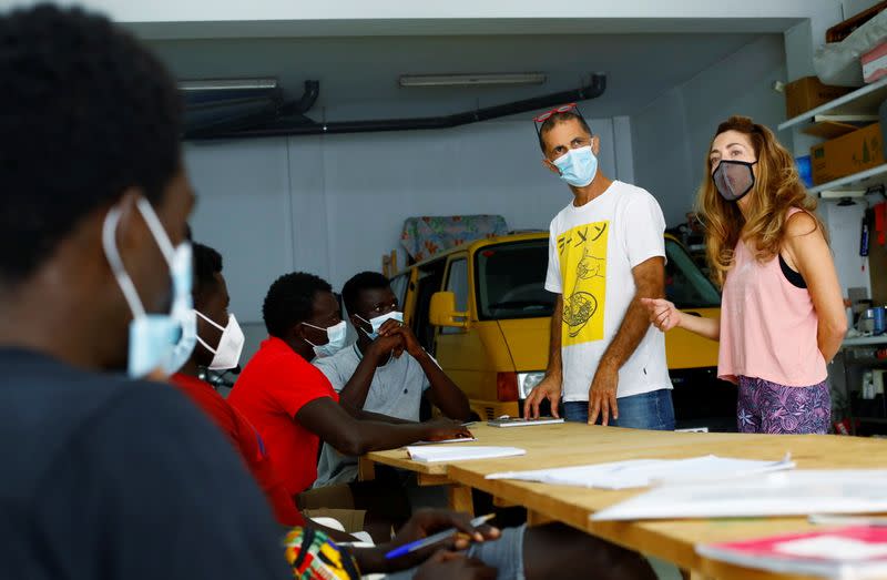 Isabel Florido and Tito Martin teach Spanish classes to a group of Senegalese migrants who arrived on the island by boat in Las Palmas