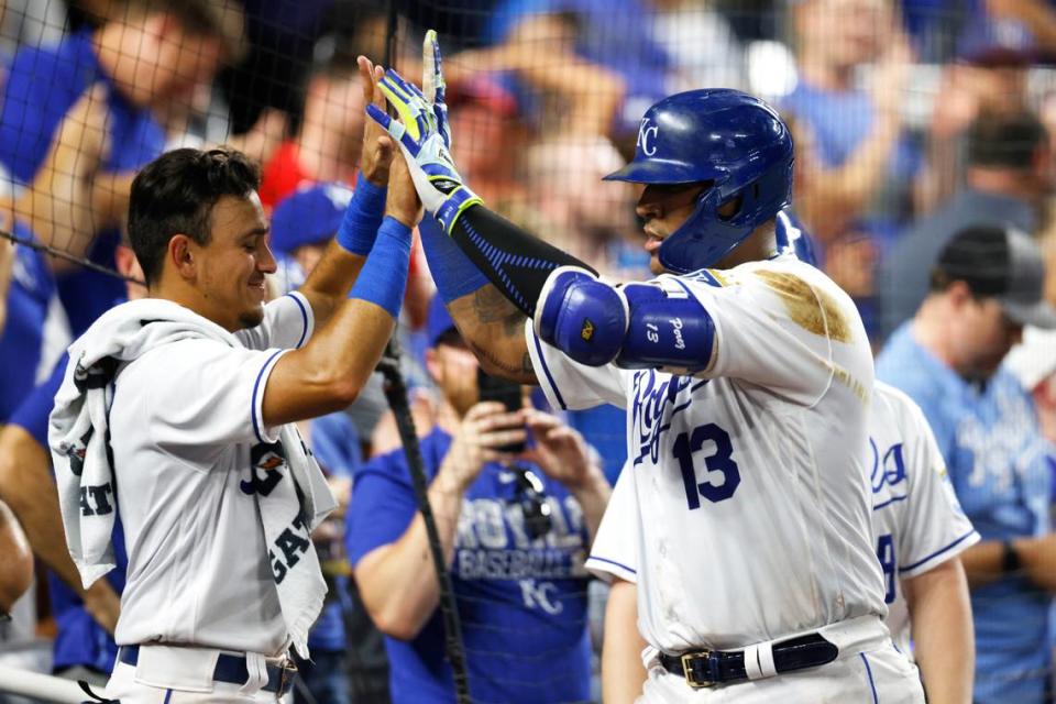 Kansas City Royals’ Nicky Lopez, left, congratulates Salvador Perez (13), who had hit a home run to tie the score during the sixth inning against the New York Yankees in a baseball game at Kauffman Stadium in Kansas City, Mo., Tuesday, Aug. 10, 2021. (AP Photo/Colin E. Braley)