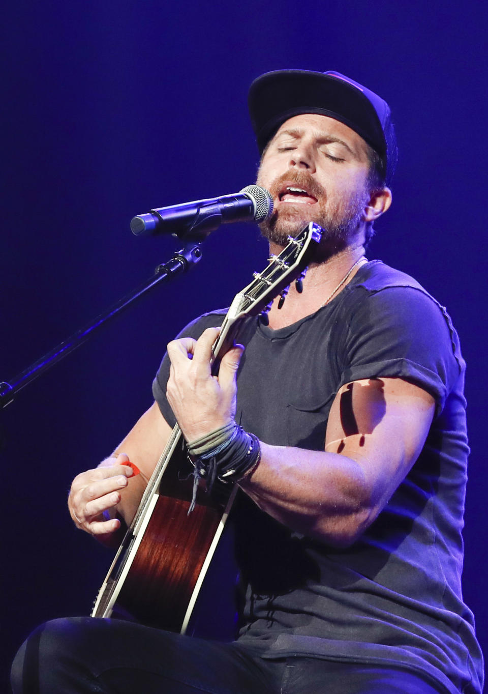 FILE - This Sept. 19, 2018 file photo shows Kip Moore performing at the 2018 Nashville Songwriters Awards in Nashville, Tenn. Moore was used to traveling the world to surf, rock climb or hike, but lately he's been isolating himself in a remote lodge in eastern Kentucky. The Georgia-born artist releases his new album “Wild World,” in a very chaotic time, but he said his introspective messages might help people right now. (Photo by Al Wagner/Invision/AP, File)