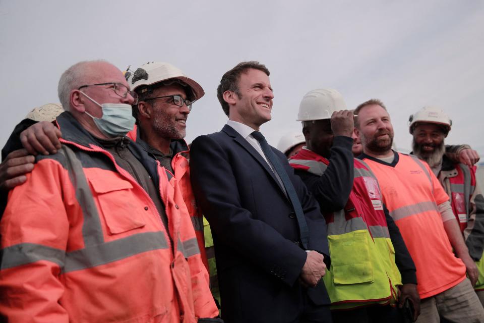 Emmanuel Macron poses with construction workers in Denain, northern France (POOL/AFP via Getty Images)