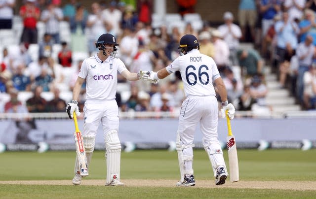 Root and Brook touch gloves in the middle 