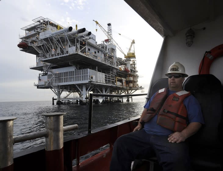 FILE - In this May 1, 2009 file photo, a crew member arrives by boat at th offshore oil drilling platform "Gail", operated by Venoco, Inc., off the coast near Santa Barbara, Calif. Leaders in the California Senate say they are introducing legislation to thwart President Donald Trump's attempts to expand offshore drilling through an executive order he signed Friday, April 28, 2017. (AP Photo/Chris Carlson, File)