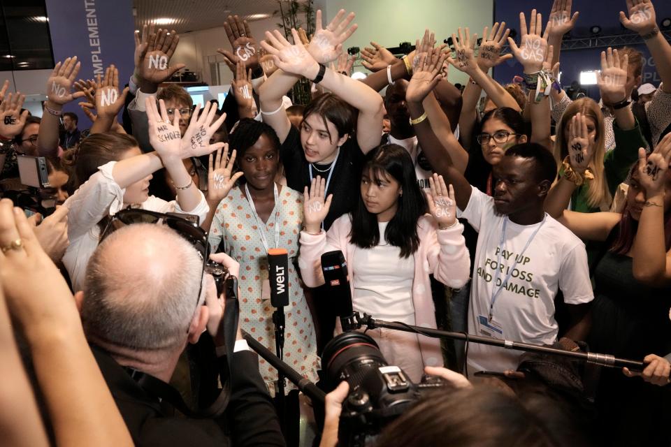 Climate activist Elizabeth Wathuti, of Kenya, center left, is joined by others of Fridays for Future to protest against Germany's Olaf Scholz's climate policy (AP)