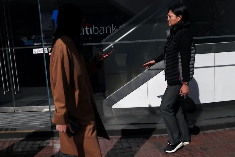 Indonesian journalist Veby Mega Indah, whose right eye was severely injured by Hong Kong police during a protest, traces her fingers along a wall to keep her balance as she walks along a sidewalk in Hong Kong, China