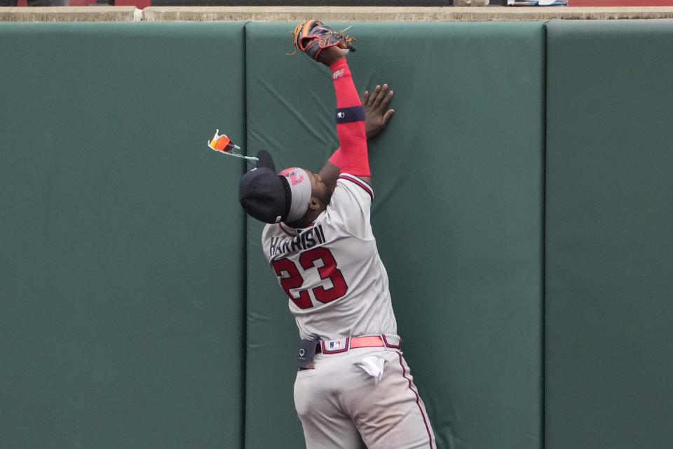 Atlanta Braves center fielder Michael Harris II (23) loses his glasses as he hits the outfield wall catching a fly ball by St. Louis Cardinals' Paul Goldschmidt to end the eighth inning of a baseball game Wednesday, April 5, 2023, in St. Louis. (AP Photo/Jeff Roberson)