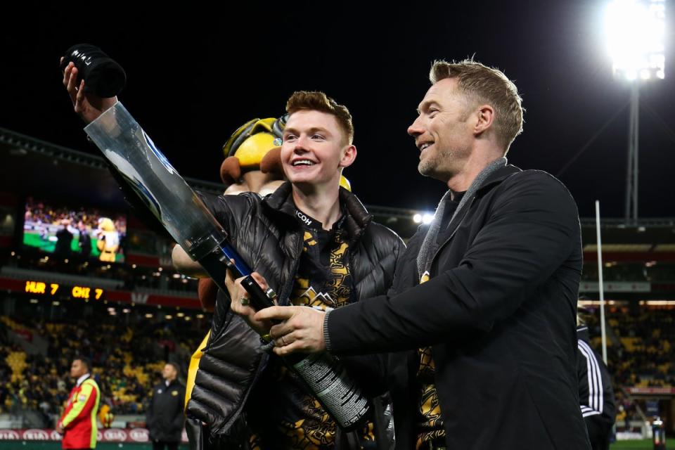 Ronan Keating and son Jack prepare to fire a tshirt cannon during the round 16 Super Rugby match between the Hurricanes and the Chiefs at Westpac Stadium in 2017 (Getty Images)