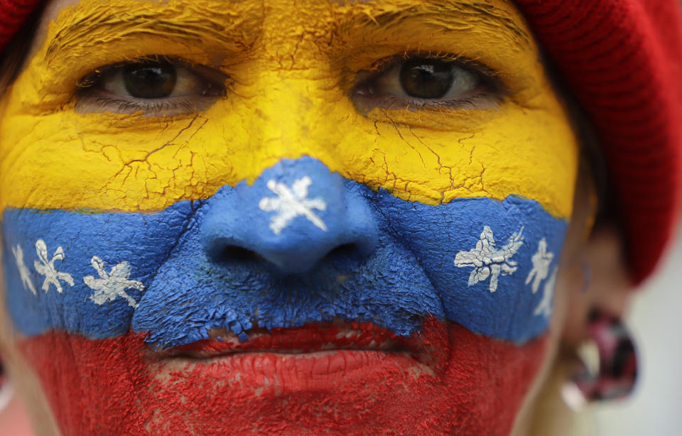 Her face painted in the colors of the national flag, a supporter of opposition leader Juan Guaido, Venezuela's self-proclaimed interim president, waits for his arrival in Los Teques, Miranda State, Venezuela, Saturday, March 30, 2019. Guaido addressed the crowd while Maduro loyalists gathered for what was billed as an "anti-imperialist" rally in the capital. Such dueling demonstrations have become a pattern in past weeks as Venezuela's opposing factions vie for power in a country enduring economic turmoil and a humanitarian crisis. (AP Photo/Natacha Pisarenko)