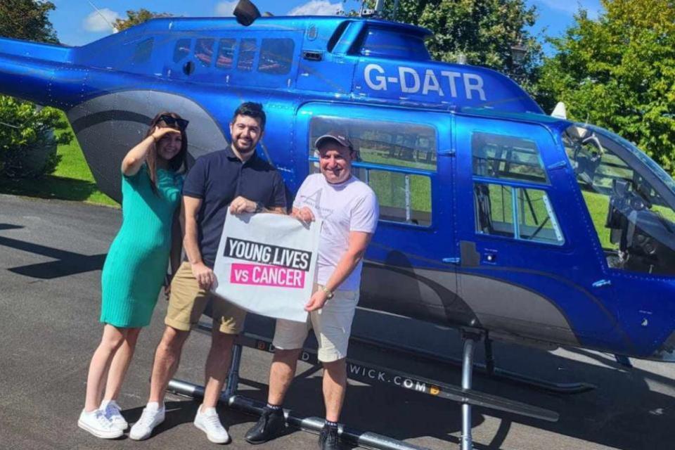 Lancashire Telegraph: Cancer-sufferer Sophie Bebb (left) and dad Adrian Bebb (middle) when they were treated to a ride on Dave Fishwick's (right) helicopter