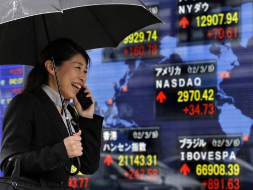 Asian markets were mixed on Friday following an uneven set of data from the United States, while sentiment was weighed by news that Spain's credit rating had been slashed