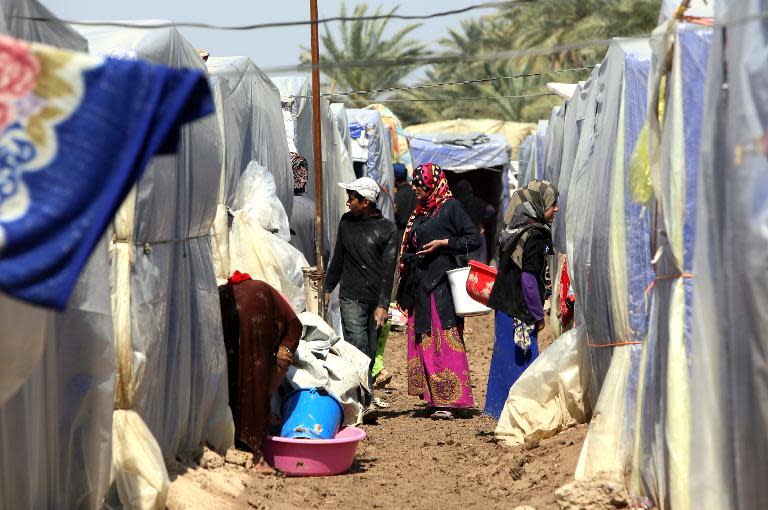 Displaced Iraqis pictured outside their tents at a camp for internally displaced persons (IDPs) in Baghdad, consisting mostly of people who fled from the conflict ridden Salaheddin province, on March 20, 2015