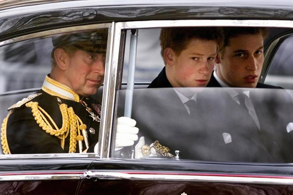 Prince Charles (L) and his sons  Prince Harry (C) and Prince William arrive at Westminster Hall before following the gun carriage carrying coffin of the Queen Mother en-route to Westminster Abbey 09 April 2002 for the Queen Mother's funeral service.  The funeral is the culmination of more than a week of mourning for the royal matriarch, who died March 30 at the age of 101.   AFP PHOTO WPA POOL GERRY PENNY (Photo credit should read GERRY PENNY/AFP via Getty Images)