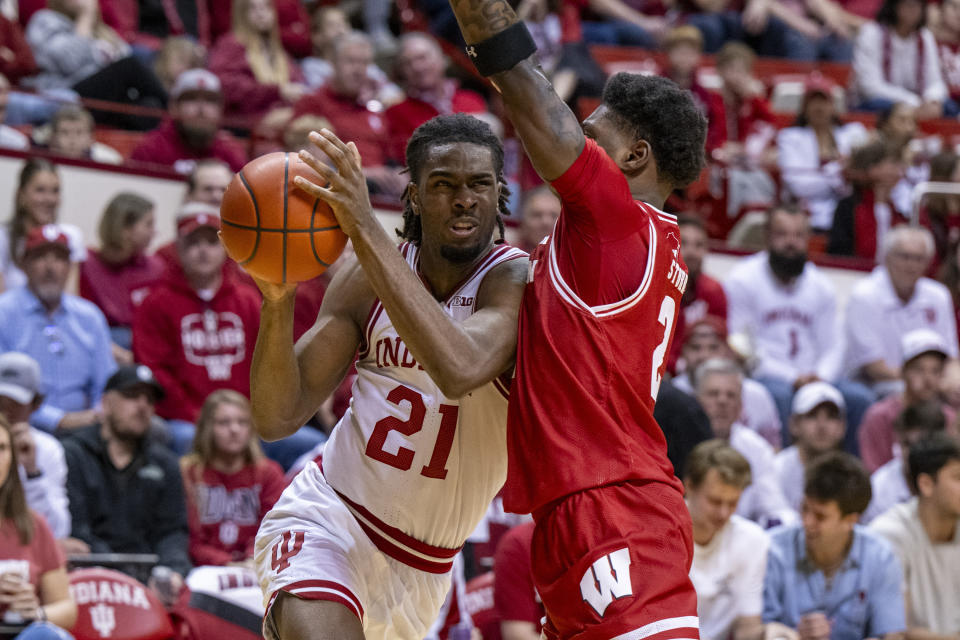 Indiana forward Mackenzie Mgbako (21) drives into the defense of Wisconsin guard AJ Storr (2) during the second half of an NCAA college basketball game, Tuesday, Feb. 27, 2024, in Bloomington, Ind. (AP Photo/Doug McSchooler)