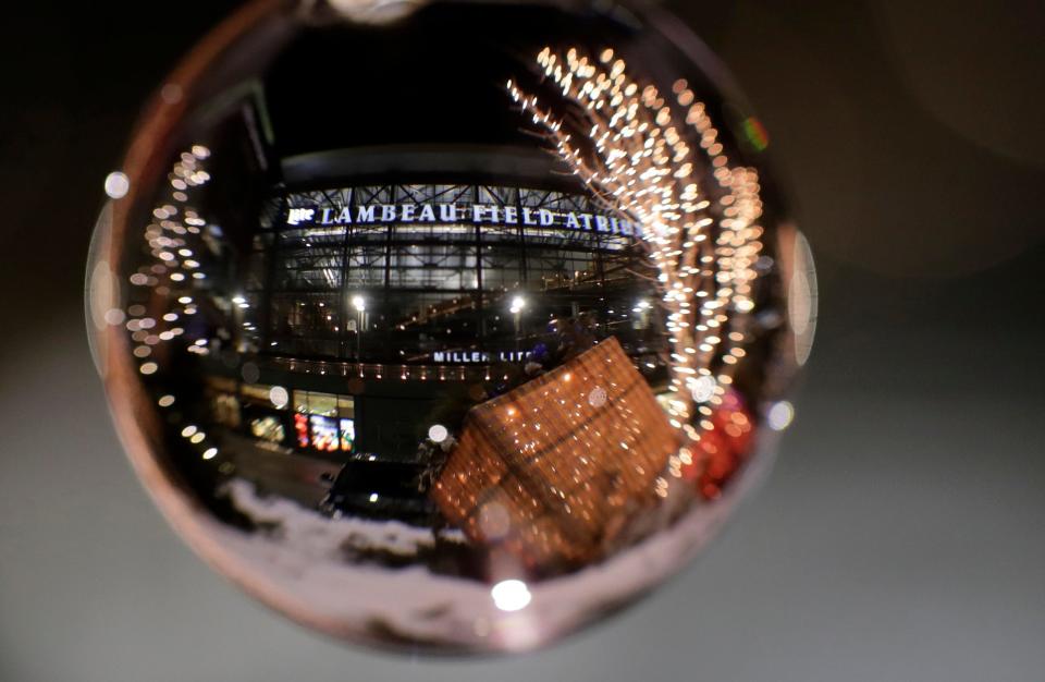 The Lambeau Field Atrium and holiday decorations are photographed through a crystal sphere on Dec. 13, 2021, in Green Bay.