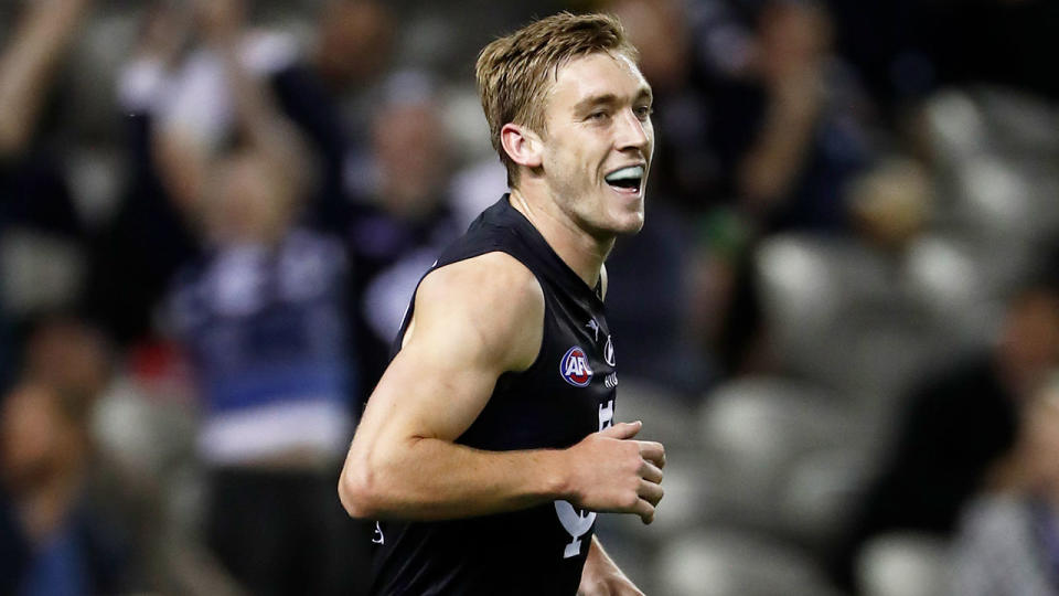 Pictured here, Carlton's Oscar McDonald smiles after kicking a goal against Richmond.