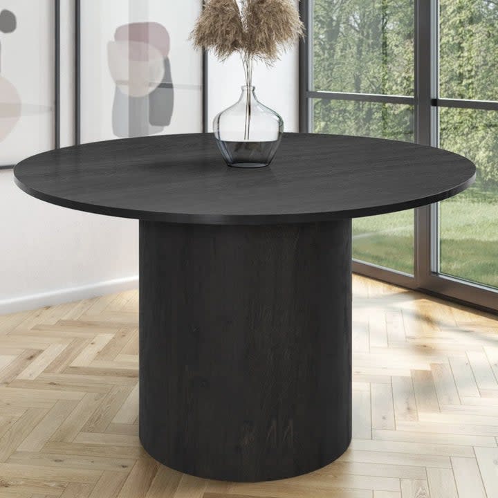 A black round dining table