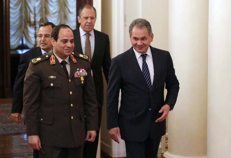 Egypt’s military chief Field Marshal Abdel-Fattah el-Sissi, second left, and Egyptian Foreign Minister Nabil Fahmy, left, are escorted by Russian Defense Minister Sergei Shoigu, right, and Russian Foreign Minister Sergey Lavrov as they enter a hall for their two-plus-two talks in Moscow, Russia, Thursday, Feb. 13, 2014. Egypt’s military chief visits Russia on his first trip abroad since ousting the Islamist president, part of a shift to reduce reliance on the United States at a time of frictions between the longtime allies. (AP Photo/Alexander Zemlianichenko)