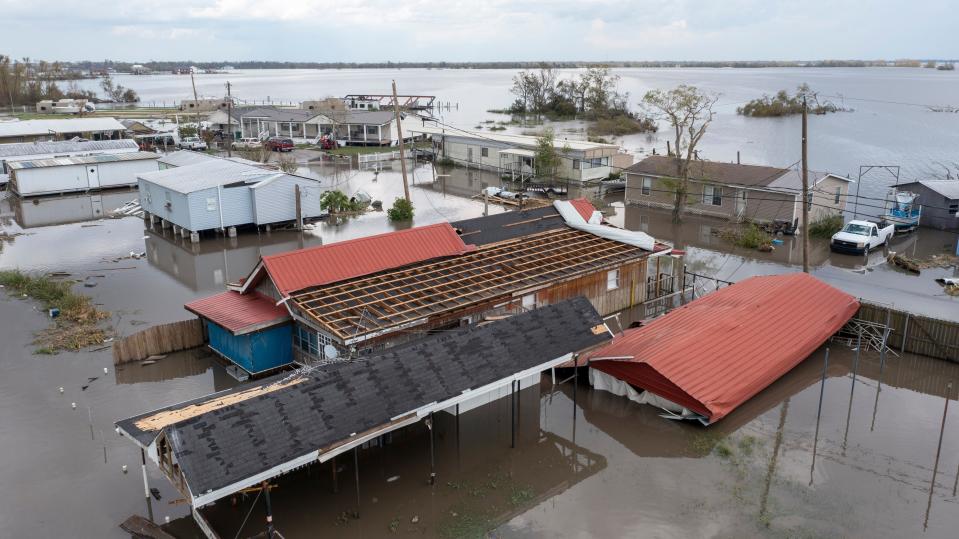 In this aerial photo taken with a drone, flood waters surround storm damaged homes, Tuesday, Aug. 31, 2021, in Lafourche Parish, La., as residents try to recover from the effects of Hurricane Ida.