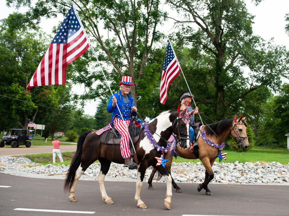 Bob and Teresa Box ride their horses during the third annual Independence Day Parade in Spring Creek, Tennessee on Tuesday, Jul. 4, 2023.