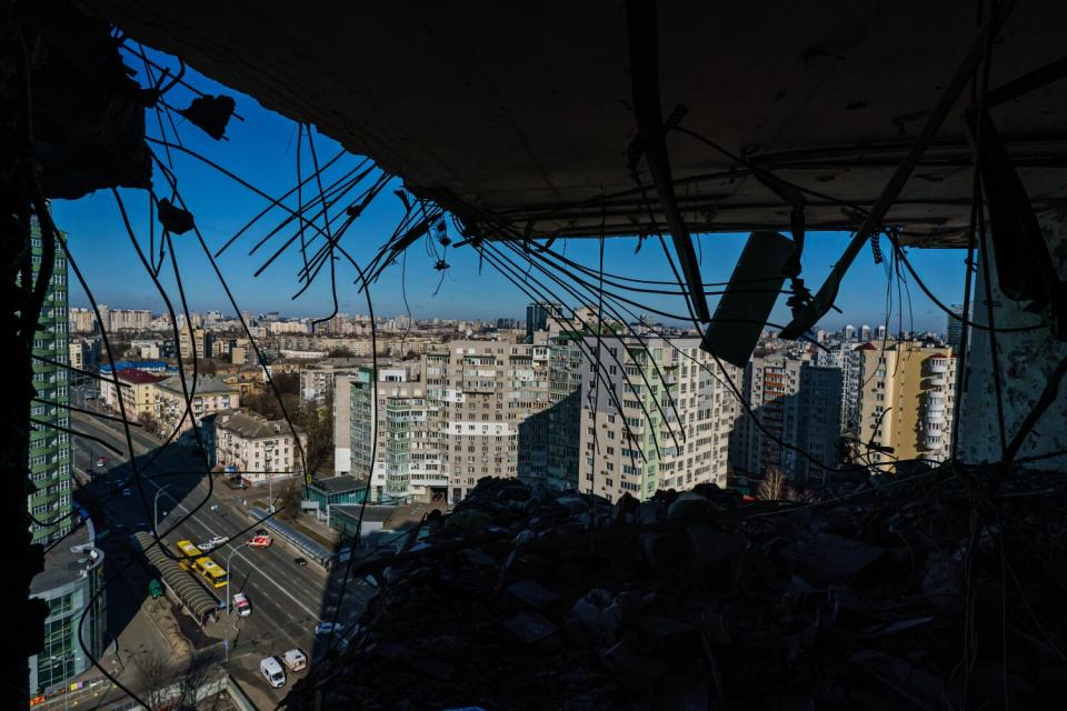 Buildings can be seen through a hole in a residential building.