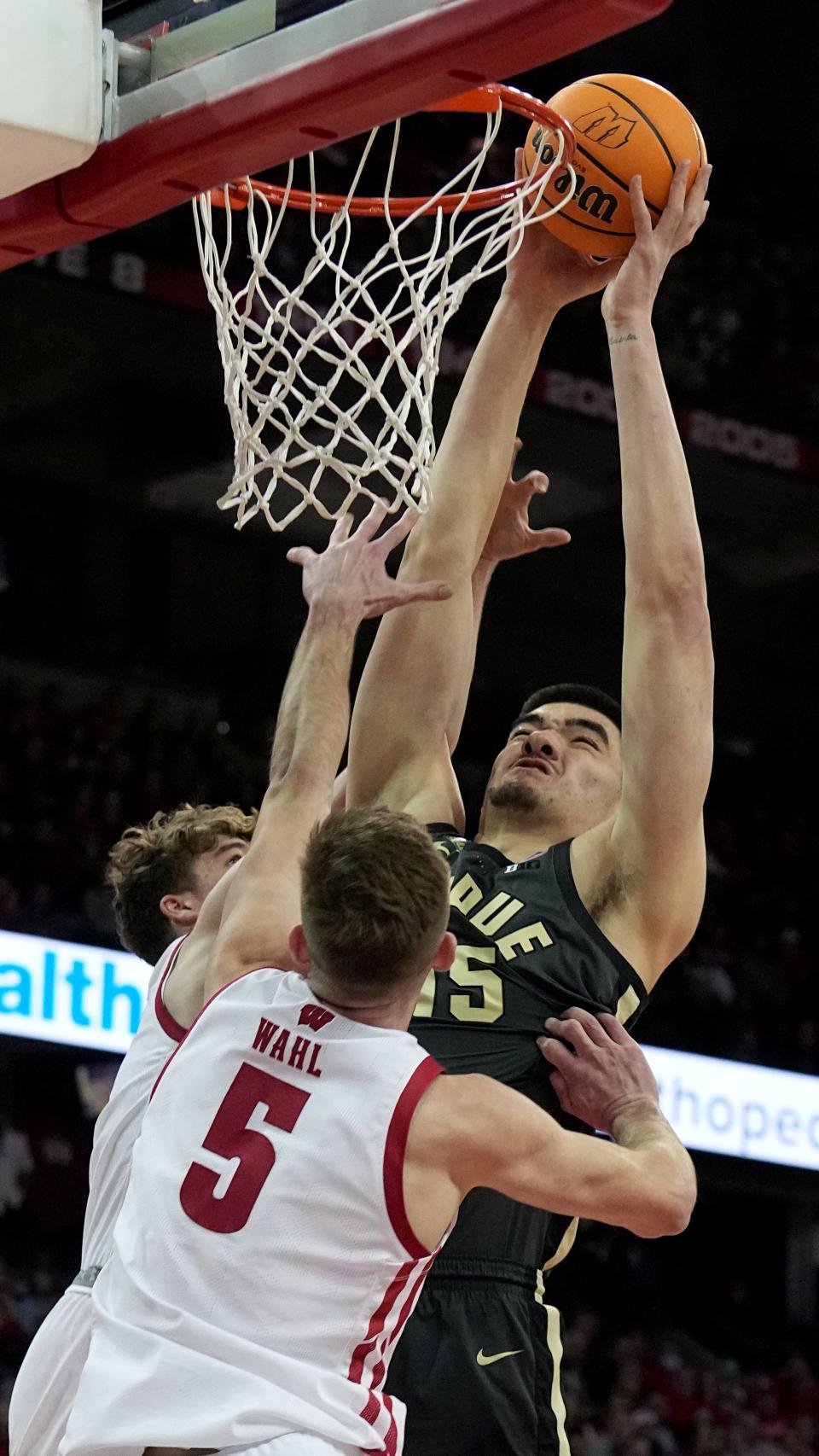 Purdue center Zach Edey (15) misses a dunk while being defended by Wisconsin forward Tyler Wahl (5) and guard Max Klesmit (11) during the first half of their game Thursday, March 2, 2023 at the Kohl Center in Madison, Wis.
