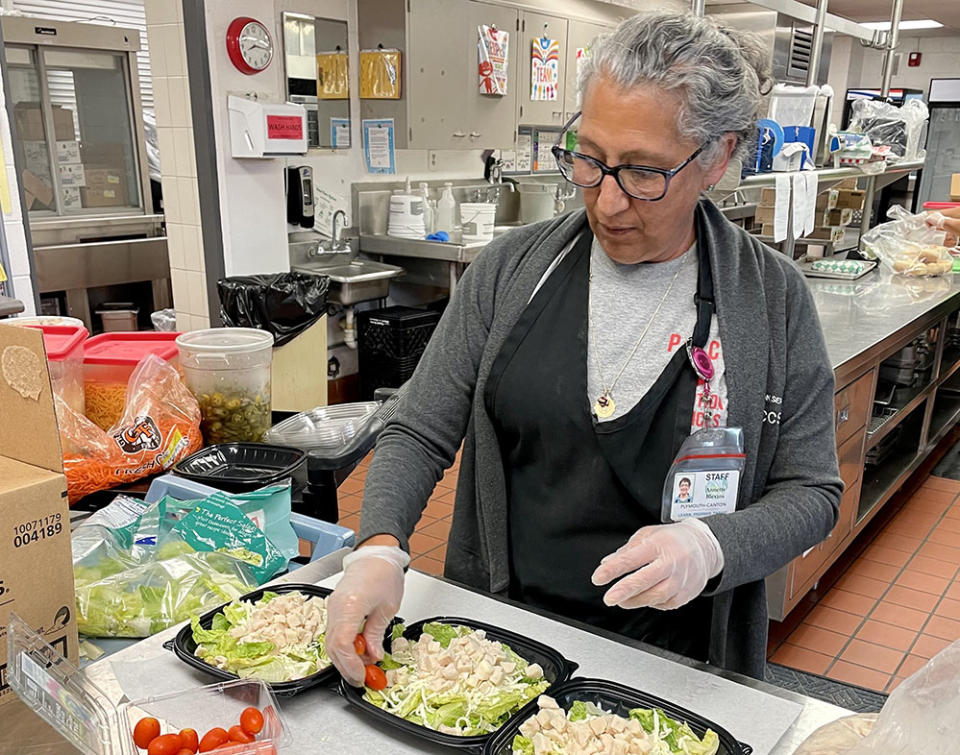 Annette Blevins, who works in nutrition services for Plymouth-Canton Community Schools, finished up chicken caesar salads at Salem High for students in summer school. (Plymouth-Canton Community Schools)