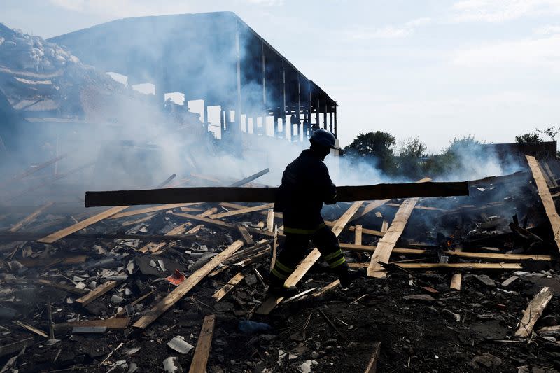 FILE PHOTO: A Ukrainian firefighter removes rubbles in a factory destroyed by a Russian strike in the city of Slovyansk